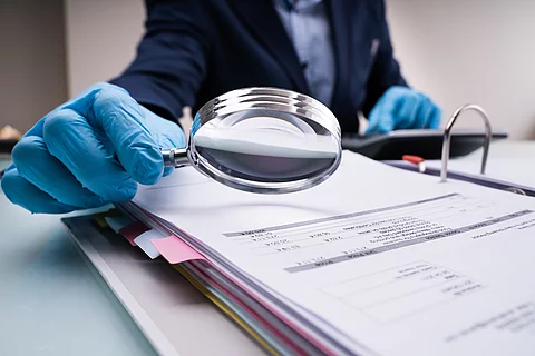 Business Fraud Investigation With Magnifying Glass