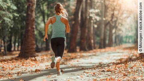 Woman Jogging Outdoors in The Fall  