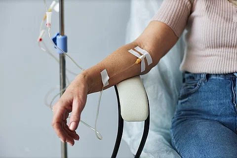 Female hand with IV drip infusion in treatment session