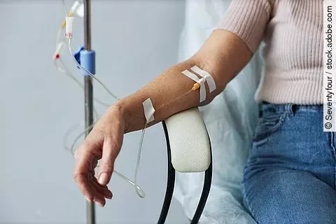 Female hand with IV drip infusion in treatment session