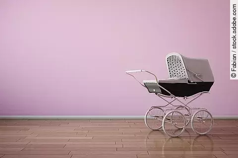 Baby stroller on pink wall horizontal
