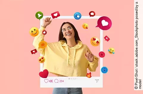 Happy young female blogger on pink background