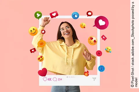 Happy young female blogger on pink background