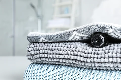 Camera hidden under towel in bathroom, closeup