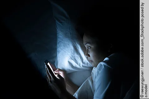 Asian woman play smartphone in the bed at night,Thailand people