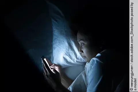 Asian woman play smartphone in the bed at night,Thailand people
