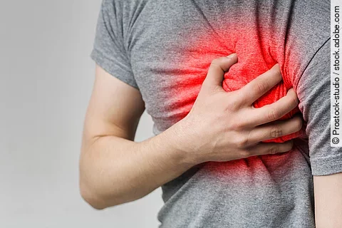 Mann hält sich linke Brust, die rot leuchtet