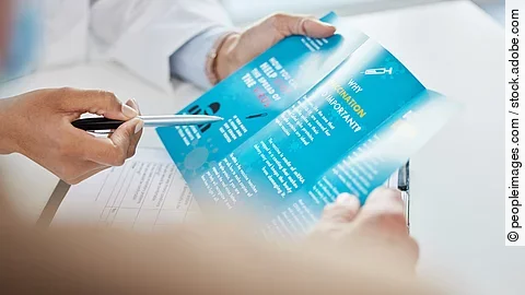Virus, brochure and hands of doctor in hospital for consulting, medical information or healthcare. Safety, pandemic and advice with patient for disease, protection or covid vaccination in clinic