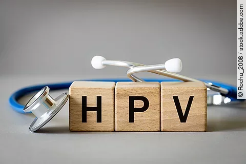 The doctor arranged the word HPV from wooden blocks, human papilloma virus, medical and health concept, medical stethoscope and gray background, close up