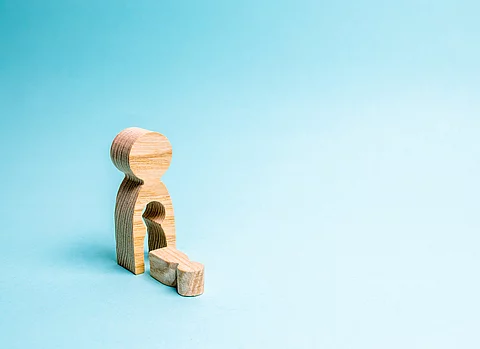 A wooden man with a void in the body from which the child fell. 
