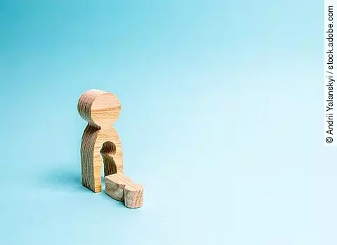 A wooden man with a void in the body from which the child fell. 