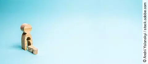 A wooden man with a void in the body from which the child fell. 