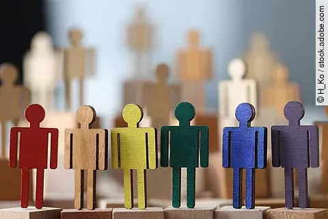 Wooden little men in lgbt colors closeup