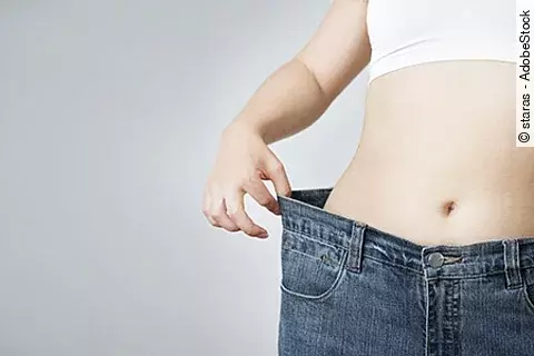 Young woman in jeans of large size, concept of weight loss