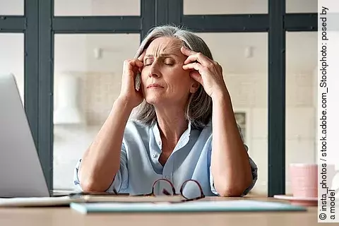 Tired stressed old mature business woman suffering from headache