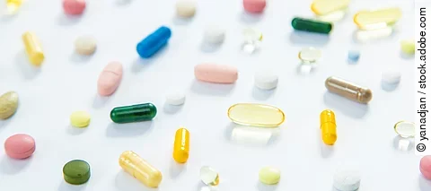 Supplements and vitamins on a white background. Selective focus.
