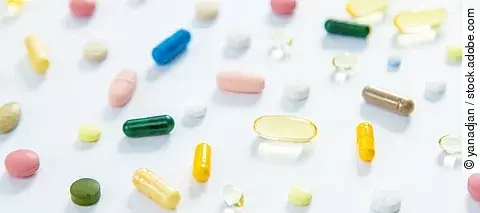 Supplements and vitamins on a white background. Selective focus.